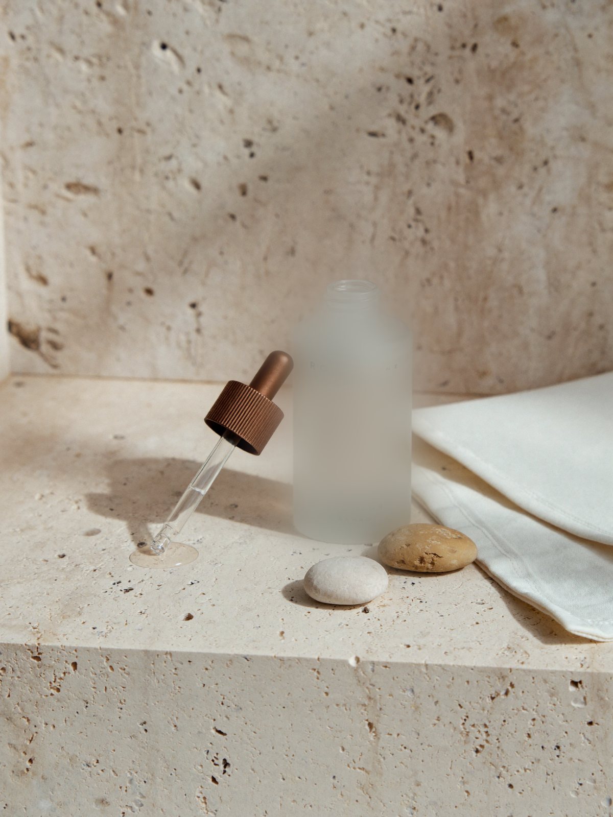 A medical-grade serum on stone &mdash; skincare made simple and deliberate.